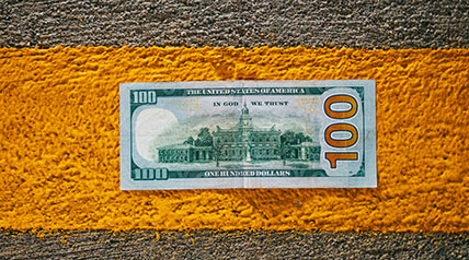 Green door with shadow of a hand reaching toward the handle to open it